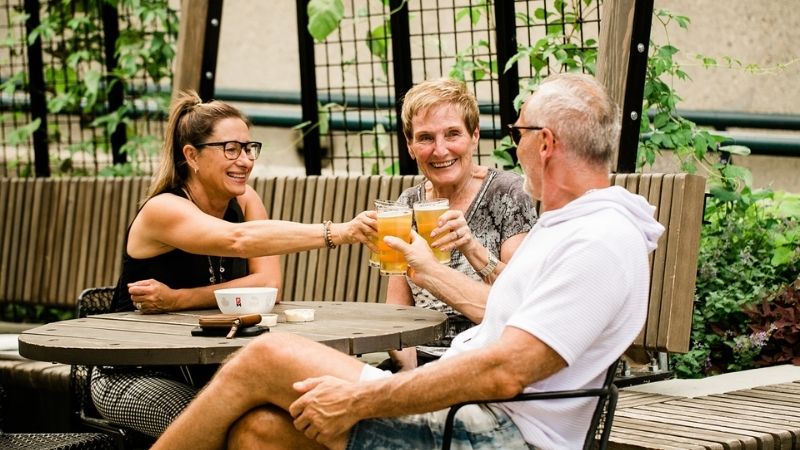A group of visitors enjoying beers on the patio.